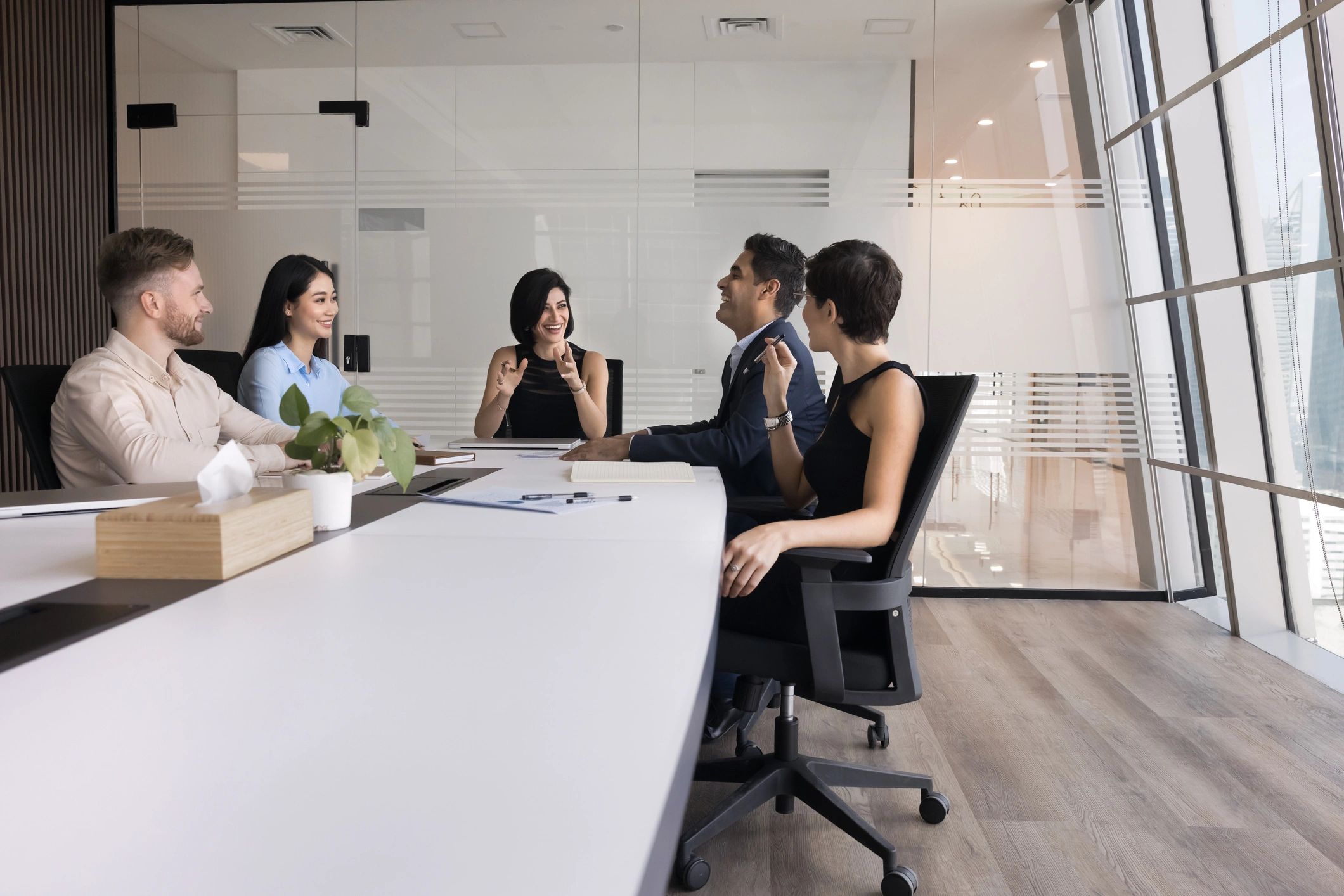 Consulting team collaborating in a modern boardroom